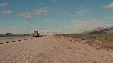 Military convoy trucks driving on highway in the desert