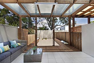 Backyard cozy patio area with wicker furniture set