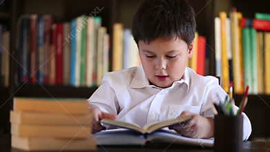 Little boy beeing bored with reading