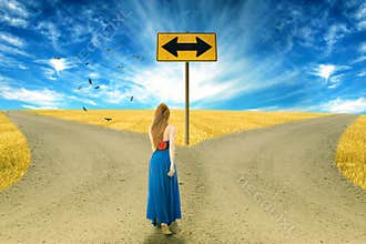 Young woman standing in front of two roads