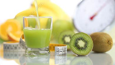 Kiwi juice poured in glass, fruit meter scales diet food