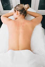 Adult woman having traditional chinese acupuncture treatment. Female back with acupuncture needle, view from above