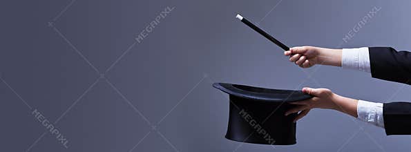Magician hands with hat and magic wand