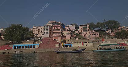 Varanasi or Banaras Ghats Riverside View from Boat on Ganges River, Colorful Boats and Historic Banaras City Scene