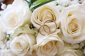 Wedding rings on a bouquet of roses