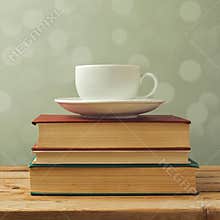 Coffee cup on old books