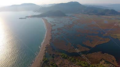 Aerial drone view of Dalyan delta lagoon marsh reeds and sandy barrier beside the sea, wetland, mugla, turkiye, lake