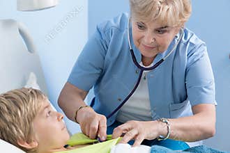 Child's doctor examining schoolboy