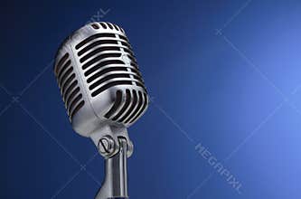 Vintage microphone on blue