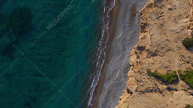 Aerial Top Down View of Rugged Coastal Cliffs and Turquoise Sea at Avdimou Bay Cyprus