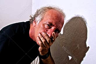 Concerned man covering mouth