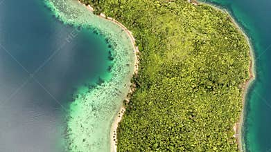 Bird-eye push-in shot of an island in Palawan, Philippines, showing a stunning contrast be