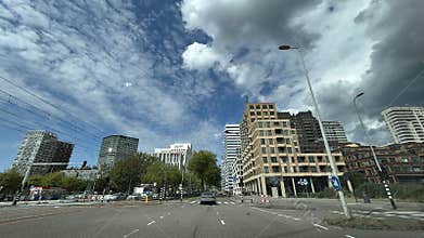 Modern Amsterdam business district streetscape with tall mixed use towers, wide