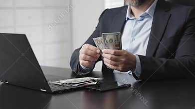 Banker counting cash in office. Banker managing finance. Banker working in office with dollar bills. Banking financial process