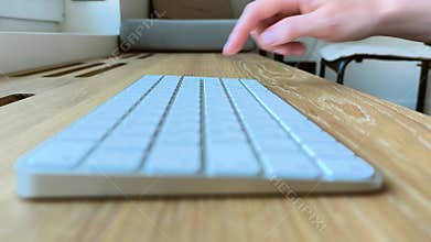 Finger pressing the Enter key from a side angle. Hand