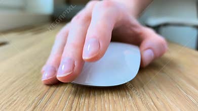 Close-up of female fingers clicking a computer mouse. Woman