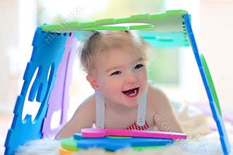 Little girl playing with puzzles