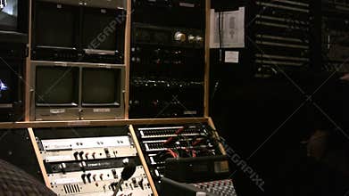 Broadcast news control room with director relaxing