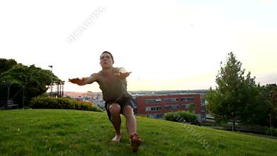Young muscular man in tank top doing one leg squat