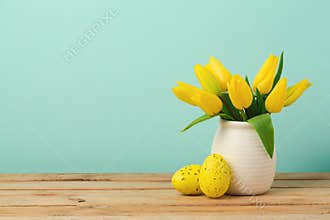 Easter holiday concept with tulip flowers and eggs decorations on wooden table