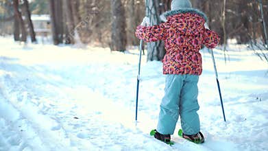 A little girl is learning cross country skiing