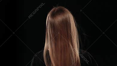 Young blonde girl with fluttering hair with wind