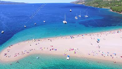 Aerial view of people sunbathing on a sandy beach on the island of Brac, Croatia
