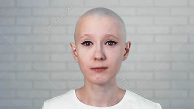 Portrait of a sad, depressed woman suffering from cancer looking into the camera