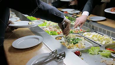 People impose food. Catering. Impose Salad. Food Distribution Table.