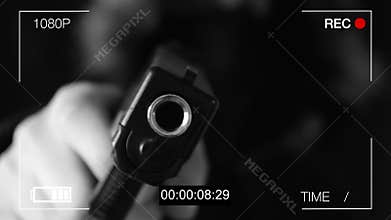 The young man points the gun at the hidden camera,black background