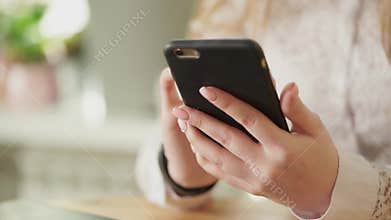 Close up shot of a young girl hands, who holding a smartphone.