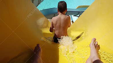 Happy boy slide on waterpark