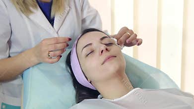 Cleaning of the face of a young girl in a Spa center