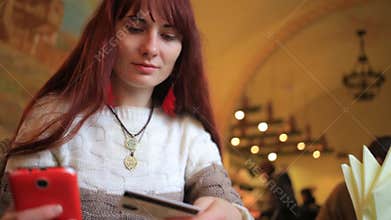 Beautiful woman online banking using smartphone shopping online with credit card at cafe lifestyle