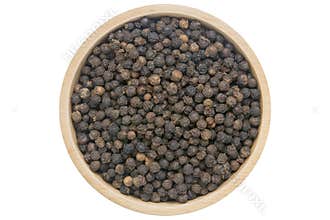 Black peppercorns in wooden bowl isolated top view on white