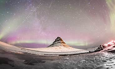 The Northern Lights and winter milky way over Kirkjufell