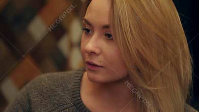 Young beautiful woman holding a glass of drink, drinking and laughing
