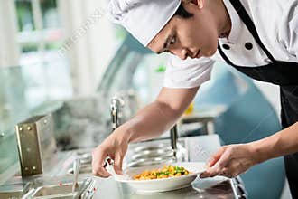 Gourmet chef plating up a dish of food
