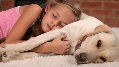 Girl sleeping on the carpet with her dog