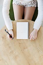 Woman`s hand writing in notebook