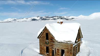 Abandon Idaho homestead in winter with snow and mountains