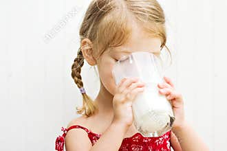 Child drinking a glass of milk