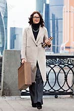 Smiling businesswoman in a light coat