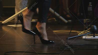 Legs of performer on the stage on the concert