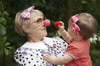 Clown playing with a little girl