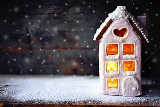Magical winter christmas picture. Gingerbread house with snow.
