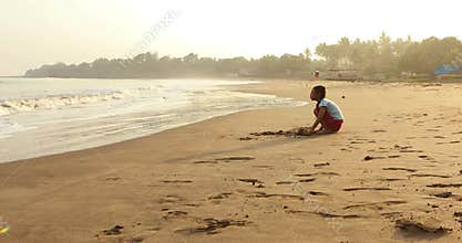 Girl playing sand alone at shore