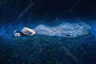 Beautiful young girl sleeps in the arms of space