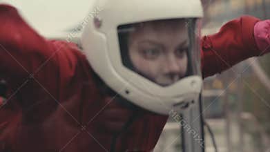Woman skydiver flying in wind tunnel. Indoor skydiving wind tunnel