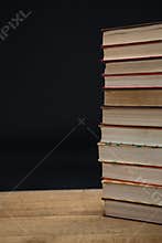 Stacked books on wooden table